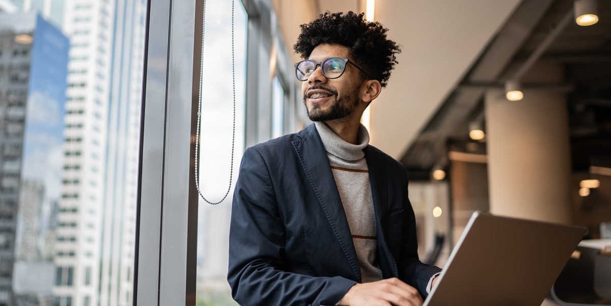 man in office, looking out window